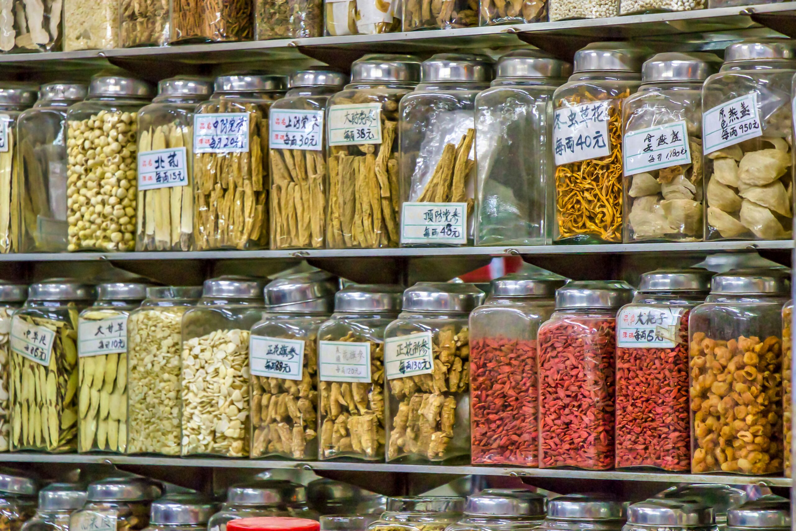Assorted bags of dog food stacked neatly in a store aisle